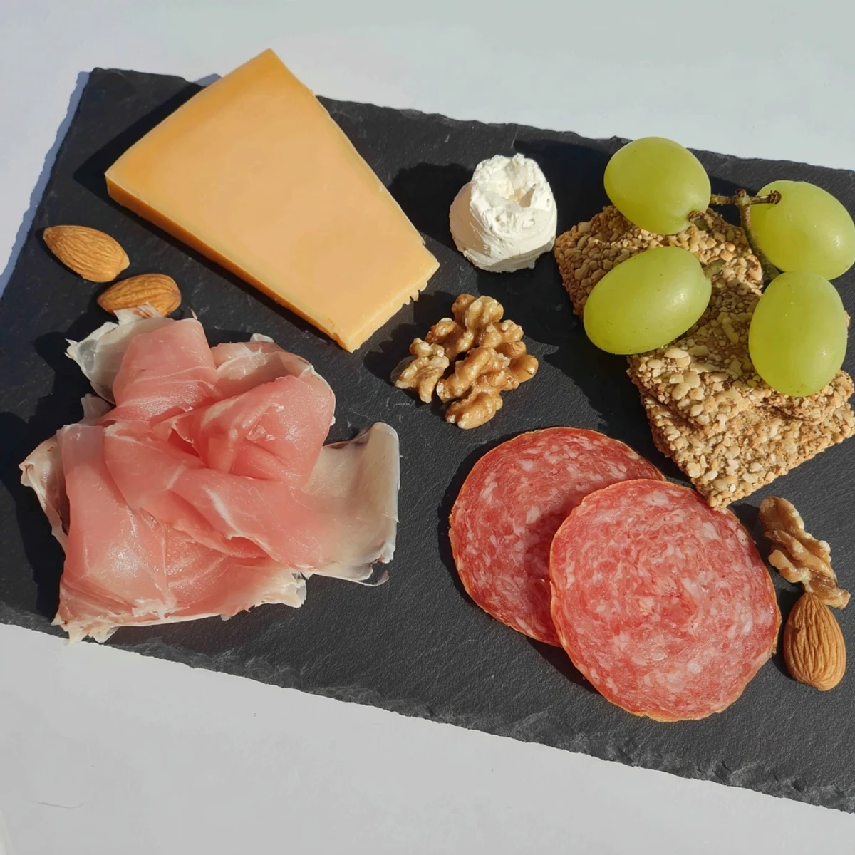 Close-up of a delightful Charcuterie Board for One, a beautifully curated gourmet snack with sweet and savory items.