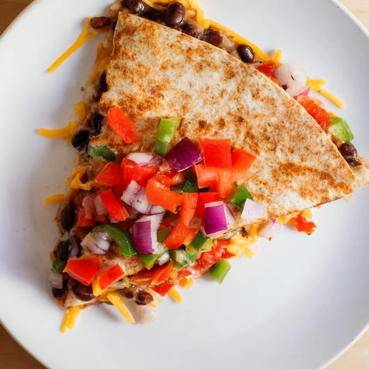 Golden, cheesy Black Bean Quesadilla, filled with a vibrant bean and pepper mixture, ready to serve.
