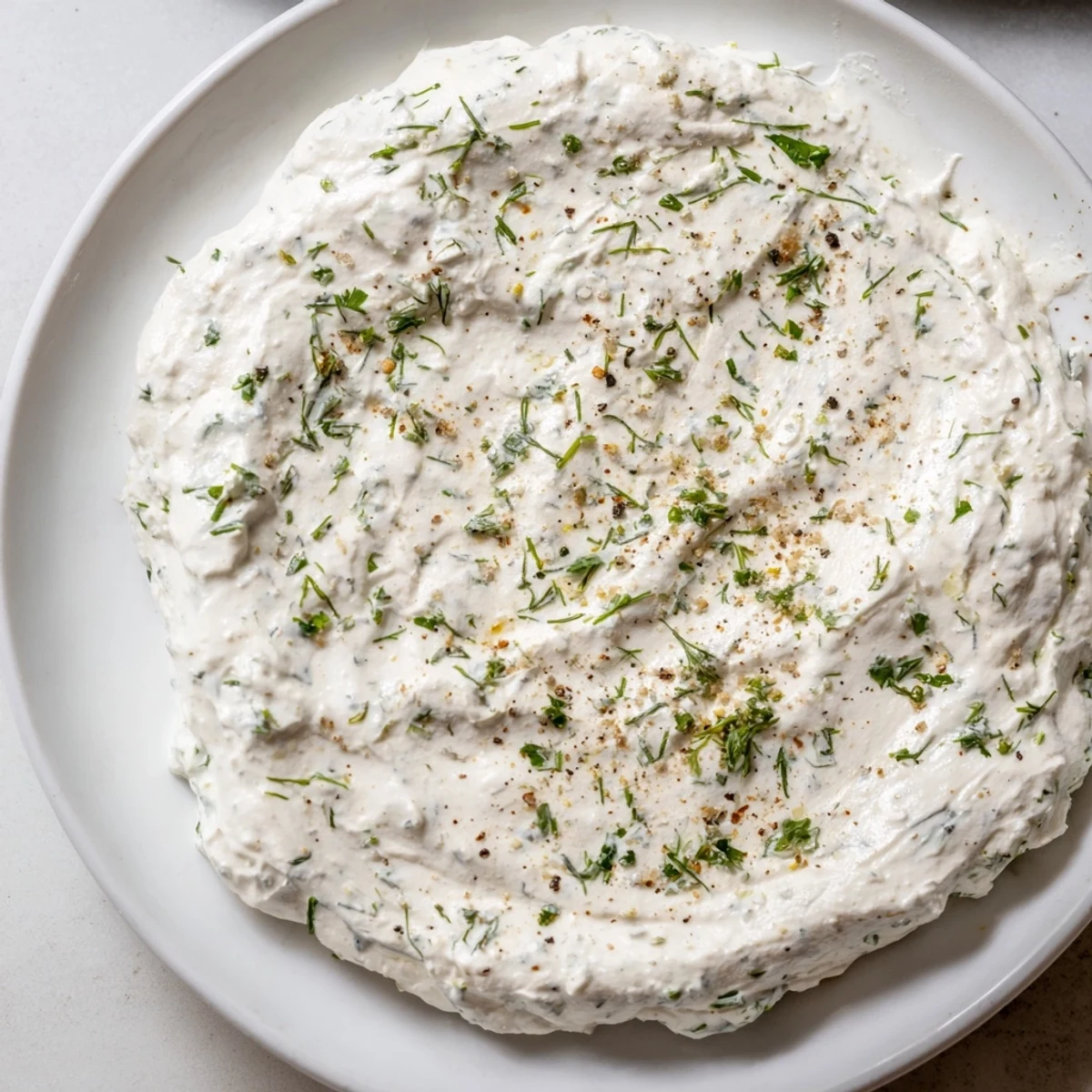 Freshly made Greek Yogurt Ranch Dip, ready to be scooped up with colorful bell peppers.