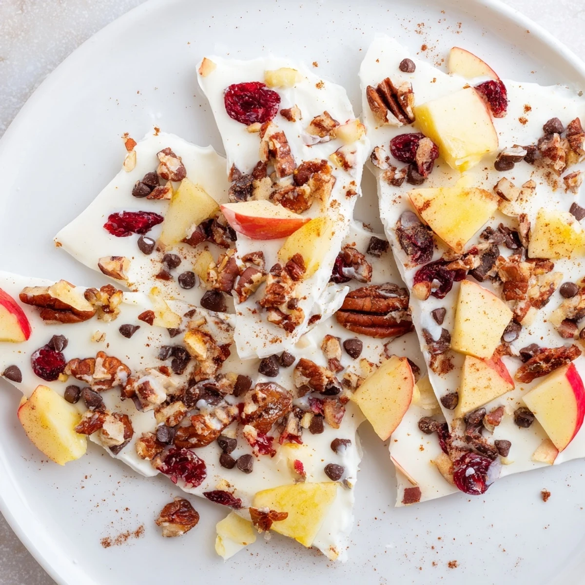 Frozen apple cinnamon yogurt bark, a refreshing treat, layered with fresh apple pieces.