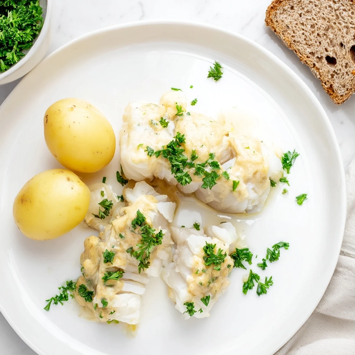 Steaming hot Norwegian Lutefisk, served with potatoes, crispbread, and a luscious mustard sauce.