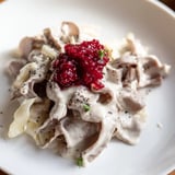 Tender reindeer meat gently simmering in a pot, the savory Finnish Reindeer Stew ready to serve.