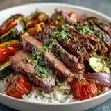 Golden roasted bell peppers and zucchini mingle with tender beef, ready to be drizzled with soy sauce over rice.