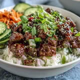 A vibrant Korean Ground Beef Bowl featuring juicy beef, cauliflower rice, and quick pickled vegetables for a low-carb, gluten-free weeknight dinner idea.