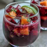 Vibrant mango dragonfruit refresher with bright pink hue, sweet tropical fruit, and refreshing citrus notes, served over ice in a clear glass.