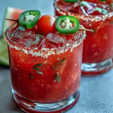 Vibrant and festive watermelon jalapeño margarita mocktail, blending fresh lime and orange juices for a zesty, alcohol-free celebration drink.