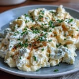 Wholesome cottage cheese and egg scramble served hot, garnished with fresh chives for a savory, nourishing start.  