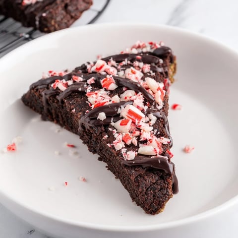 Warm, buttery Chocolate Peppermint Shortbread Wedges, drizzled with dark chocolate and crushed peppermint for a festive treat.