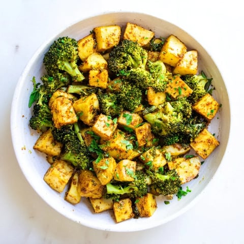 Golden, crispy Roasted Lemon Potatoes and Broccoli, seasoned with smoked paprika and ready to serve.