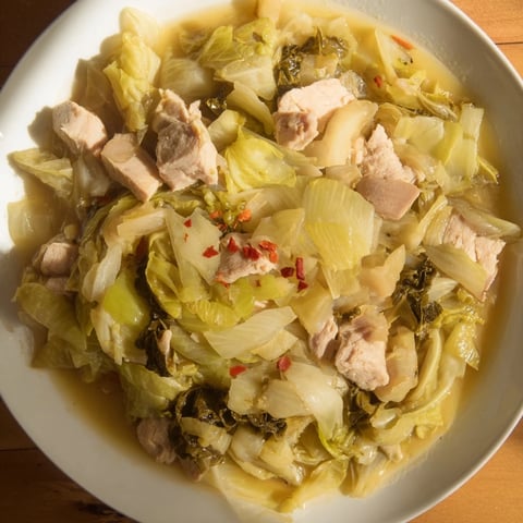 Steaming bowl of Smoky Southern Collard Greens with Smoked Turkey, ready to serve with cornbread.