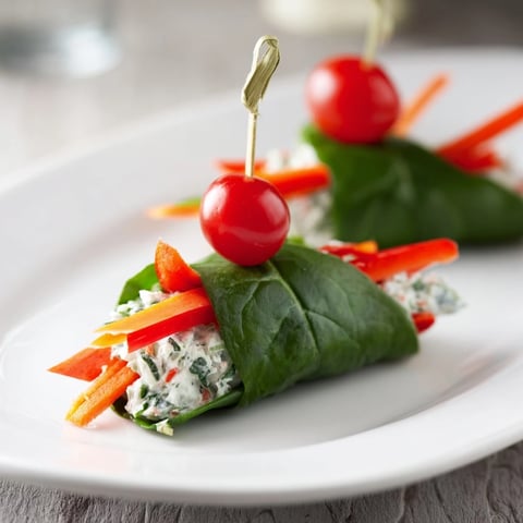 Holly Leaf Spinach Wraps: vibrant green wraps filled with creamy herb cheese and colorful vegetables.
