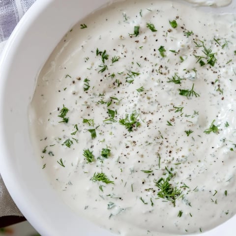 Creamy Greek Yogurt Ranch Dip, perfect for dipping crunchy veggies, featuring fresh herbs.