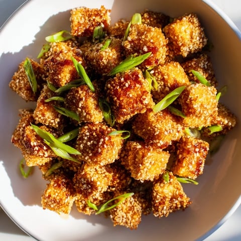 Golden, crispy Honey Sriracha Tofu Nuggets with a sweet and spicy glaze ready to enjoy.