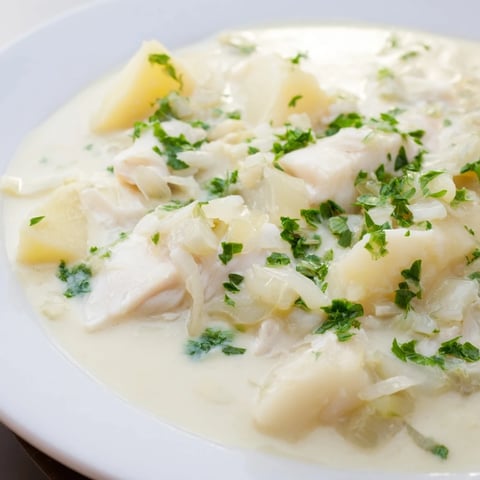 Creamy Icelandic Fish Stew, filled with tender fish and potatoes, and garnished with fresh herbs.
