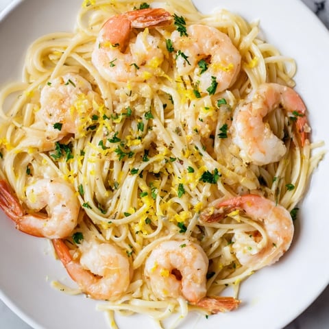 A close-up view of Garlic Butter Shrimp Linguine featuring plump pink shrimp coated in a glossy garlic butter sauce tossed with al dente linguine and fresh parsley garnish.