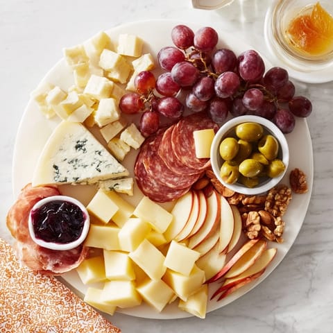 A beautifully arranged Moonlight Picnic Board featuring cheeses, fruits, and charcuterie perfect for sharing.