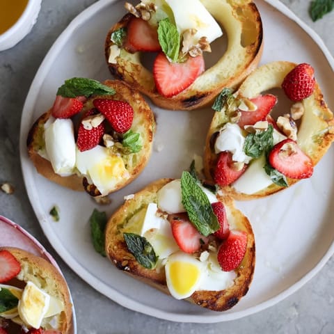 Good Morning Sun Breakfast Board overflowing with fresh fruits, cheeses, and baked goods for sharing.