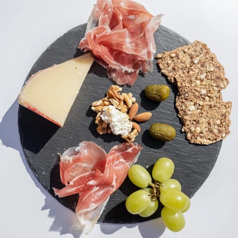 This Charcuterie Board for One features a tempting selection of cured meats and artisanal cheeses, perfectly portioned.