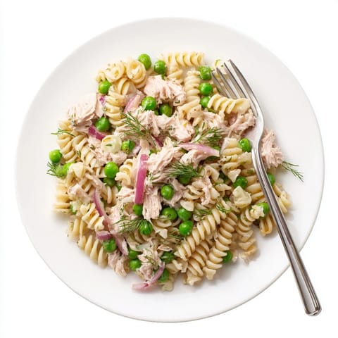 Bright and refreshing Lemony Tuna Pasta Salad in a white bowl, garnished with parsley and lemon zest for a perfect picnic lunch.  