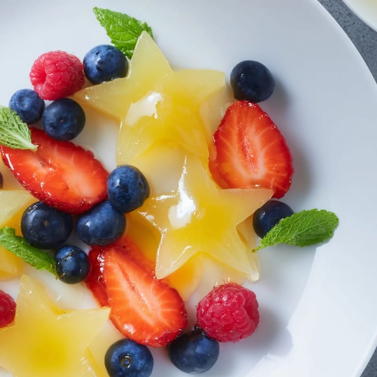 Fresh sliced starfruit and berries arranged beautifully on a platter, ready to serve as a snack.