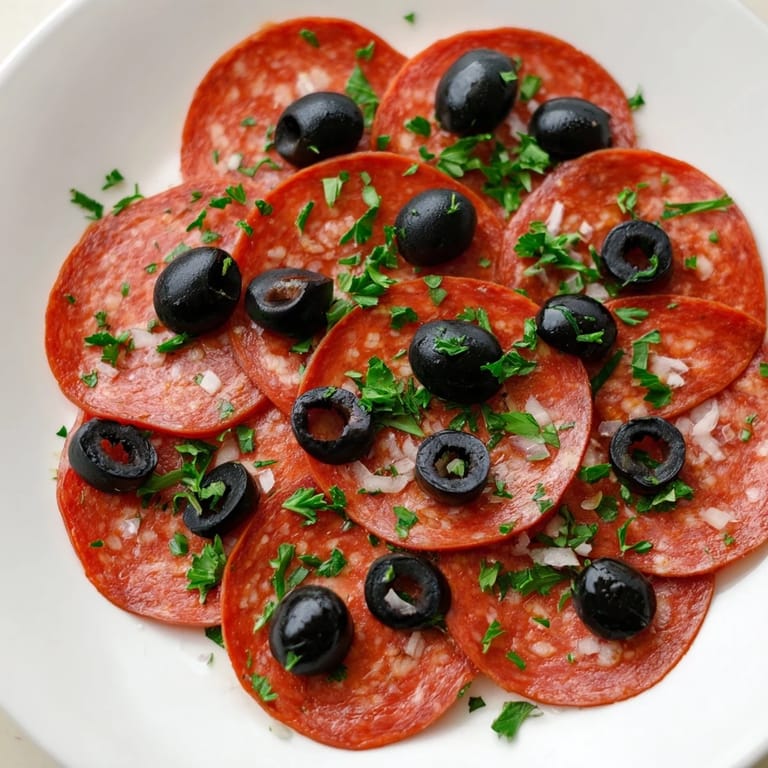 Close-up of Sliced Pepperoni and Olive Halves: salty pepperoni and glistening olive halves ready to be enjoyed.