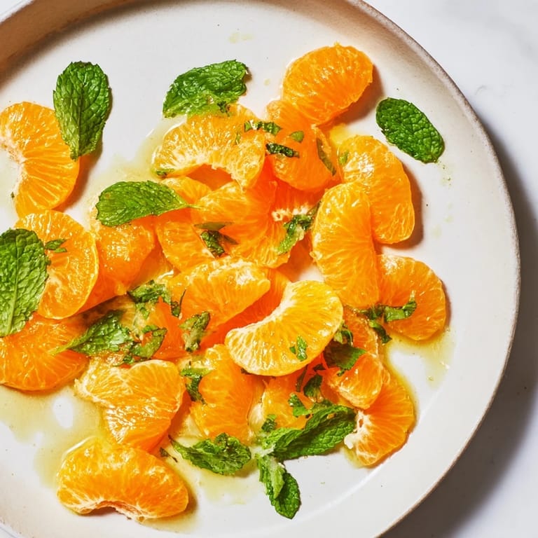 A close-up view of the easy clementine and mint winter fruit salad, bursting with citrus flavor.