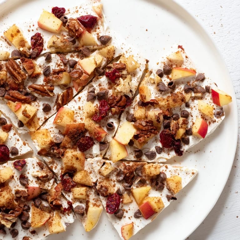 A close-up of apple cinnamon yogurt bark, a perfect dessert, with visible toppings and a creamy texture.