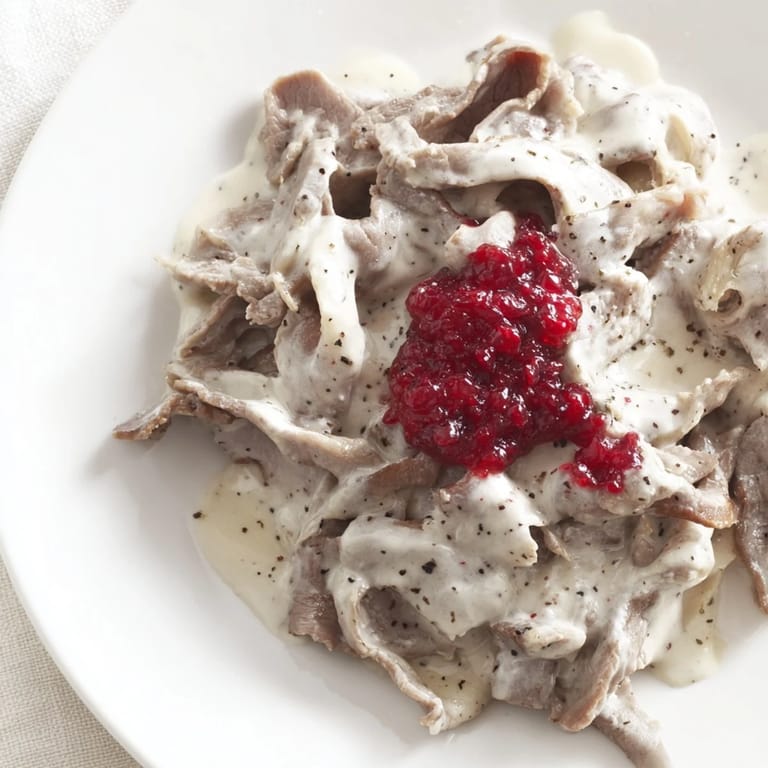 Hearty and flavorful, this Finnish Reindeer Stew is paired with creamy mashed potatoes and lingonberries.