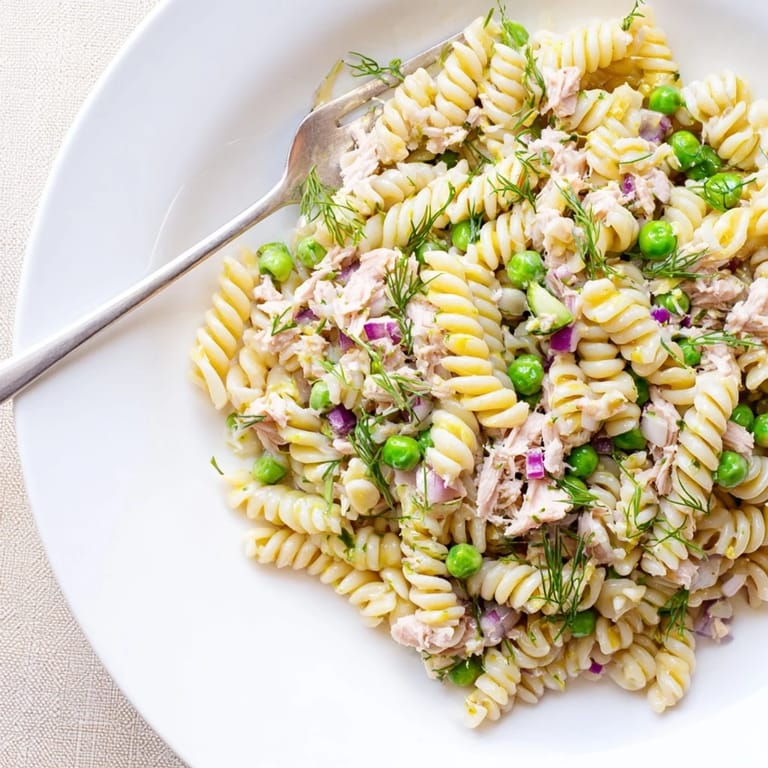Hearty Lemony Tuna Pasta Salad with flaked tuna, peas, and al dente pasta, served ready to enjoy for a light dinner.