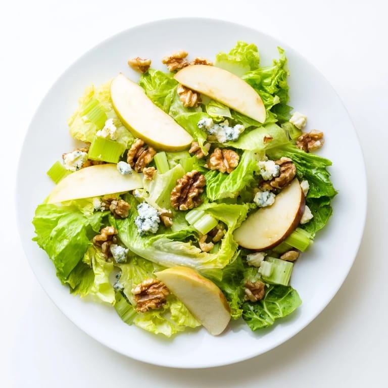 Freshly prepared Apple and Walnut Salad with crisp apple slices, crunchy walnuts, and a bright lemon-honey vinaigrette.  