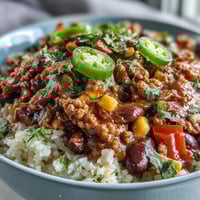 Chili Bowl Base ladled over fluffy white rice, topped with sour cream and avocado.