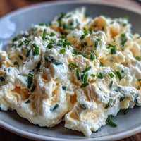 Creamy cottage cheese scrambled eggs with fluffy texture and golden hue, perfect for a high-protein breakfast.  
